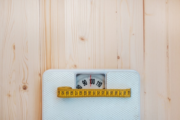 Photo scales and measuring tape for the waist on the wooden boards