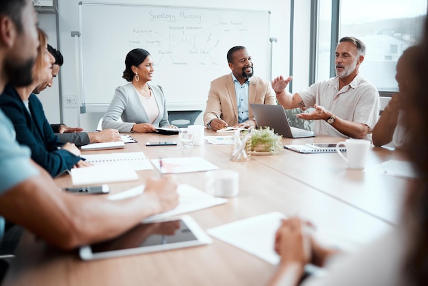 Scaling down will help our budget Shot of a group of staff listening to their boss during a business meeting