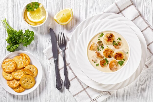 Scallops with white wine cream sauce in bowl