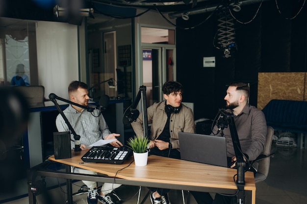 Scandal interview Two young outraged guests answering provocative questions of cheerful friendly radio hosts during live radio show