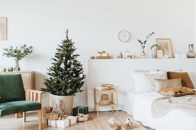 Scandinavian interior design apartments decorated in Christmas style with toys, gifts, fir tree.