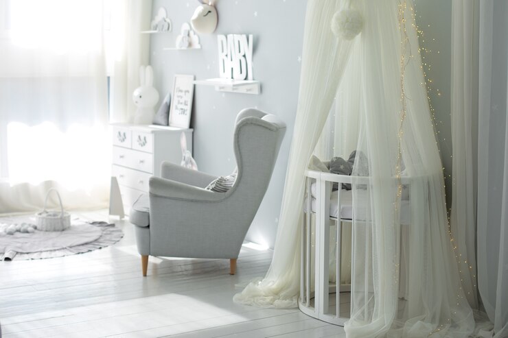 scandinavian interior of newborn baby room with bed and armchair