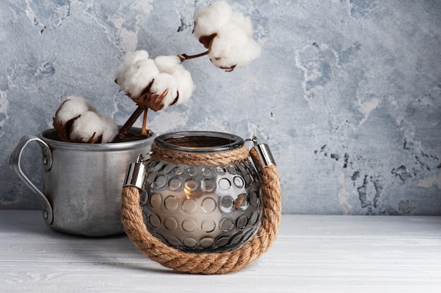 Scandinavian interior with cotton flowers and lit candles