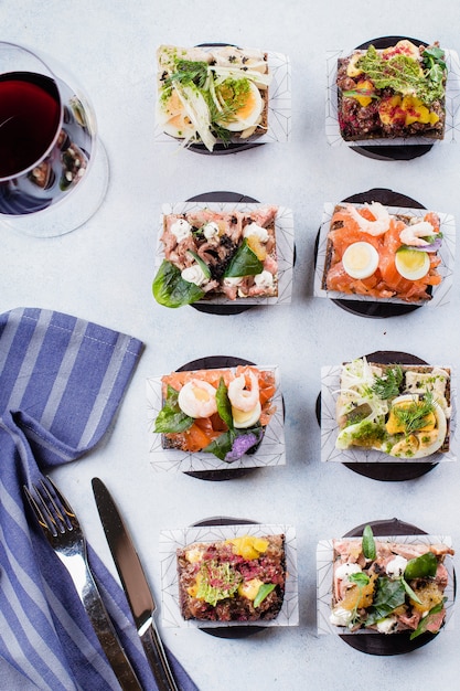 Scandinavian snack. Smorrebrods. Traditional Danish open sandwiches, dark rye bread 