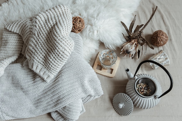 Scandinavian style teapot with knitted tea and decor details top view