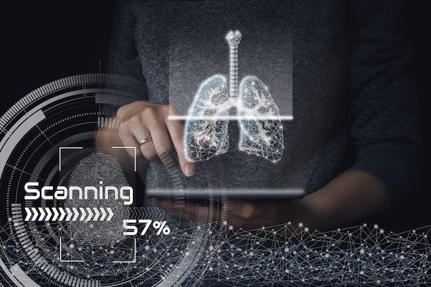 Scanning human lungs on tablet gologram. Dark background. The concept of a healthy lungs.