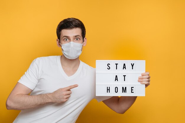 Scared guy points with finger at banner with text