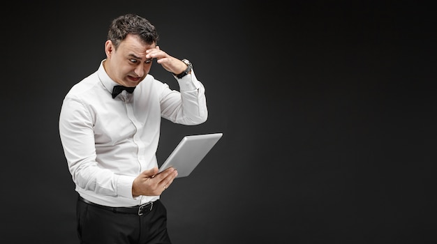 Scared man looking at tablet screen