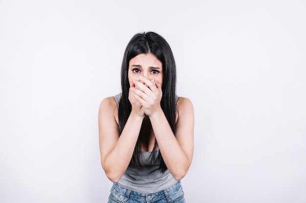 Scared woman covering mouth