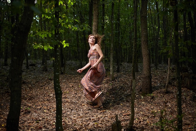 Scared woman running through the forest