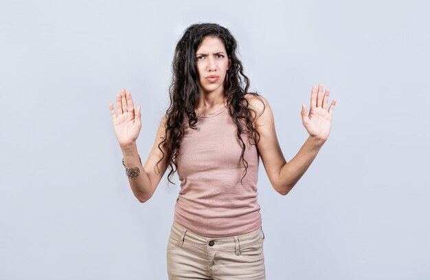 Scared woman with raised hands isolated Young woman with scared face with raised hands Scared and horrified girl with raised palms