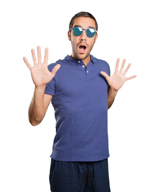 Scared young man on white background