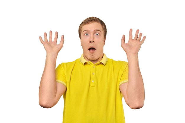 Photo scared young man with hands up in yellow polo tshirt white isolated background