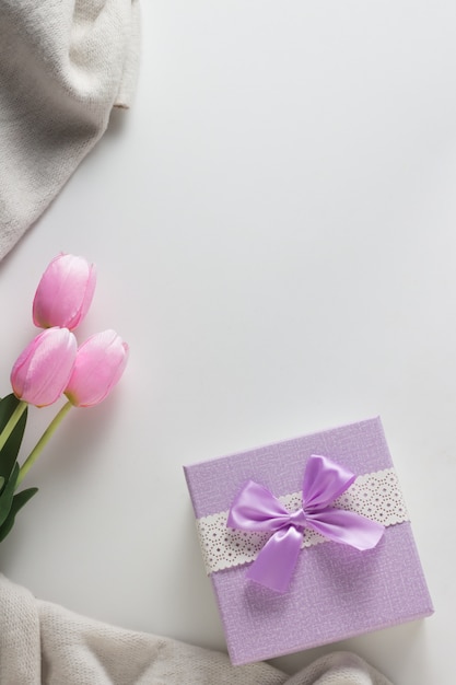 Scarf, Tulips, Gift Corby on the White surface. Spring Concept. Flat lay, top view