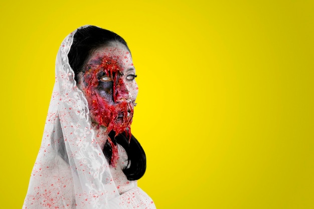 Scary bride ghost with bloody face stare at camera