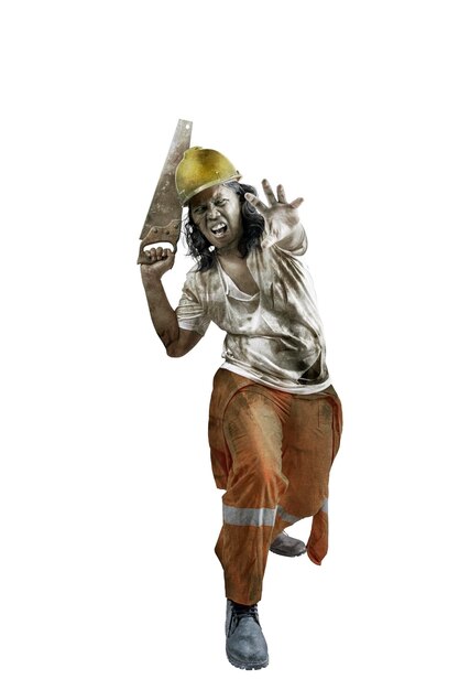 A scary construction worker zombie with blood and wounds on his body walking while carrying a saw isolated over a white background