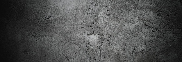 Scary dark walls slightly light black concrete cement texture for background Brush scratches on the wall