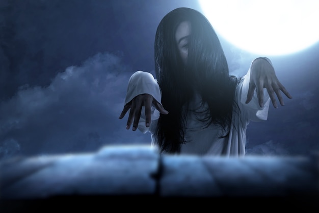 Scary ghost woman standing with night scene background. Halloween concept