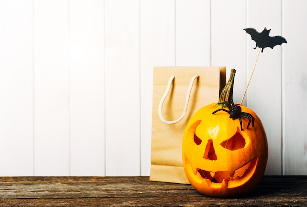 Photo scary halloween pumpkin with bats on white.