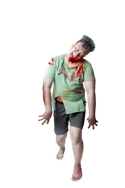 Scary zombie with blood and wound on his body standing isolated over white background