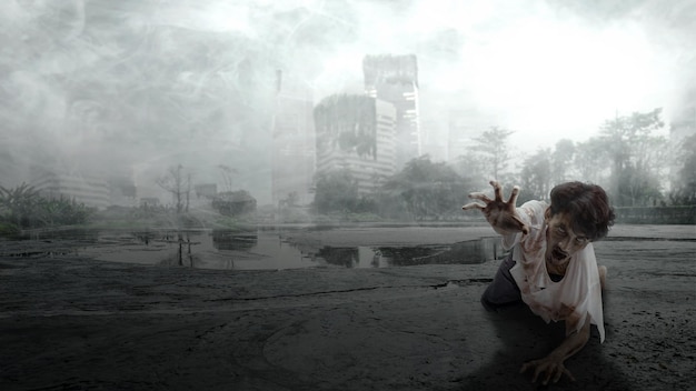 A scary zombie with blood and wounds on his body is crawling in the ruined city Scary zombie Halloween concept