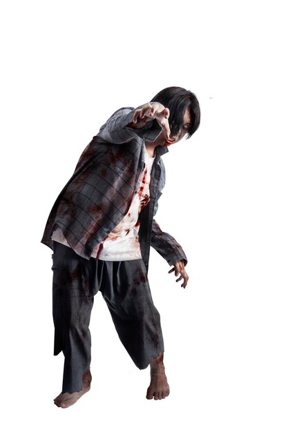 Photo a scary zombie with blood and wounds on his body walking isolated over a white background