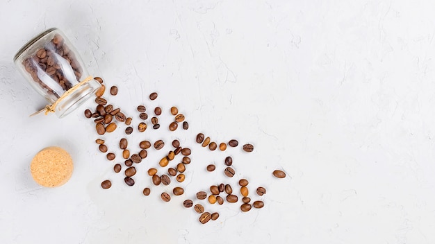 Scattered coffee beans from a jar