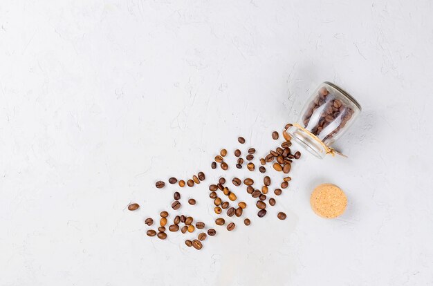 Scattered coffee beans from a jar