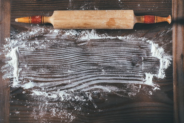 Scattered flour on wooden board