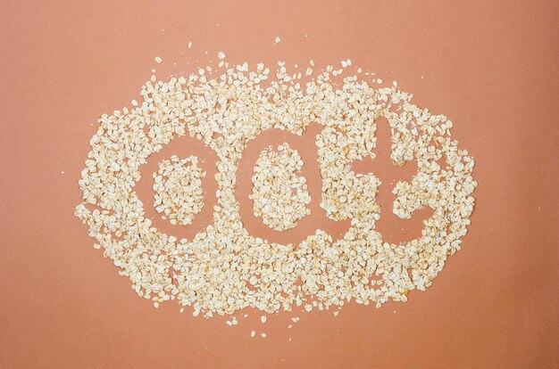 Scattered oatmeal on beige background