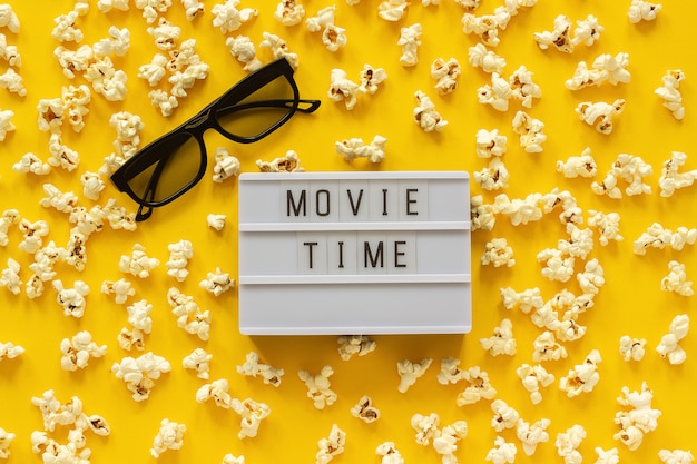 Photo scattered popcorn, 3d glasses and lightbox text movie time. top view template