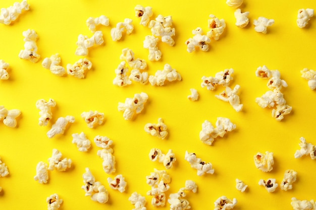 Scattered popcorn on color background