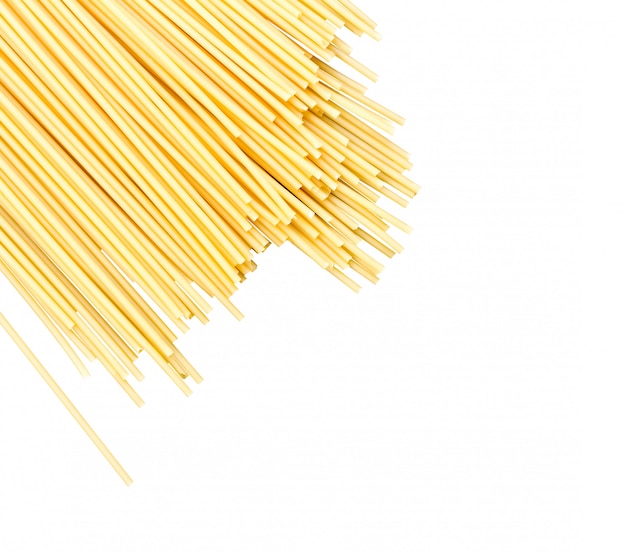 Scattered raw spaghetti noodles isolated with space for text