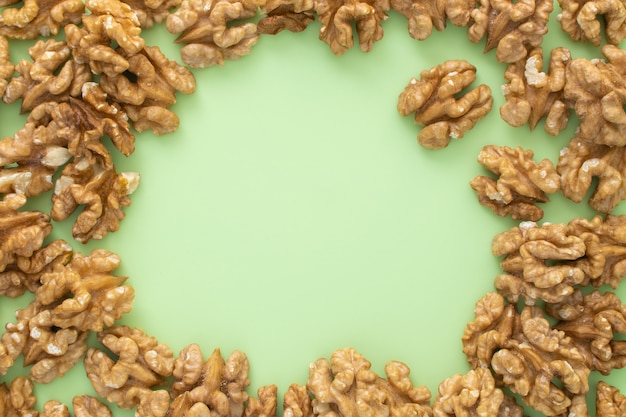 Scattered walnuts on green background. Nuts background.  , commercial banner template