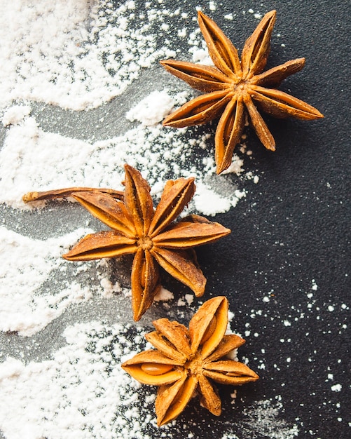 Scattered with powder and cinnamon on a black table top view