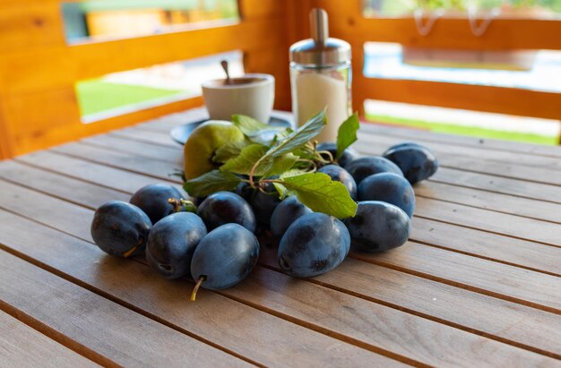 A scattering of ripe fresh plums on the table collected in the summer