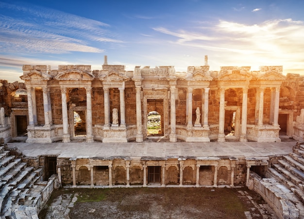 Scene and columns with sculptures of ancient amphitheater in Hieropolis