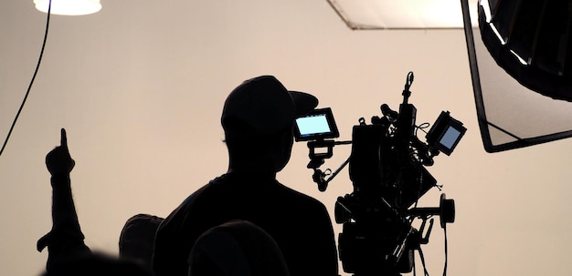 behind the scene of tv movie video film shooting production crew team and camera lighting set in the big studio.