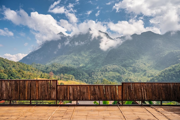 Scenery of doi luang chiang dao mountain with clouds covered from wooden balcony ban na lao mai viewpoint at chiang dao, chiang mai, thailand