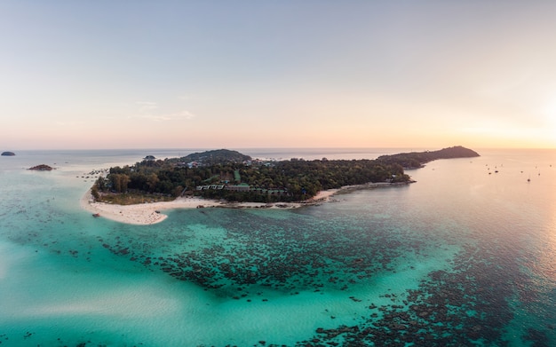 Scenery of Lipe island with coral reef in tropical sea at sunset