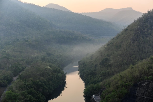 Scenery of river in rainforest valley with foggy in morning