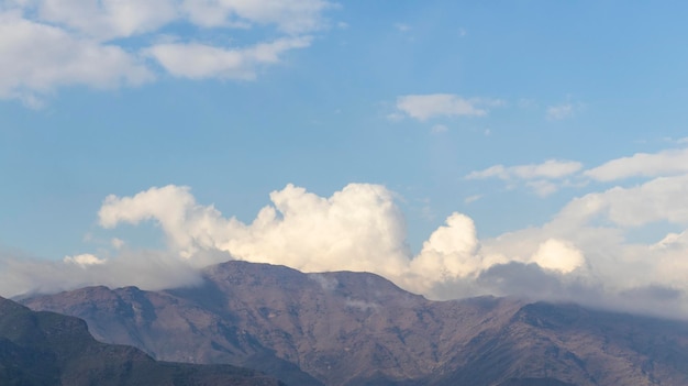 Scenery view of mountains with clouds and blue sky