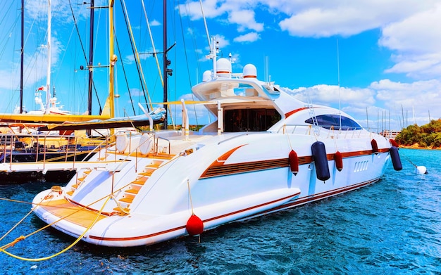 Scenery with Marina and luxury yachts at Mediterranean Sea of Porto Cervo in Sardinia Island of Italy in summer. Landscape View on Sardinian town port with ships and boats in Sardegna. Mixed media.