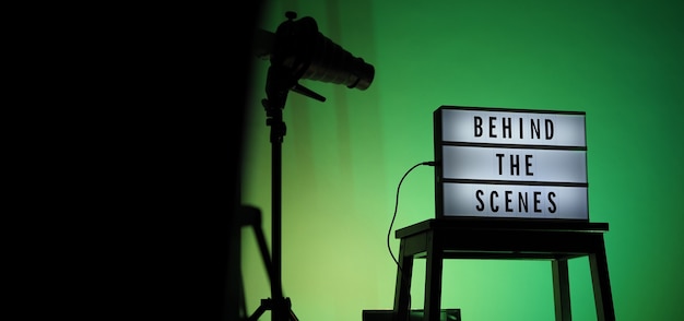 behind the scenes letterboard text on lightbox or cinema light box. movie clapperboard megaphone