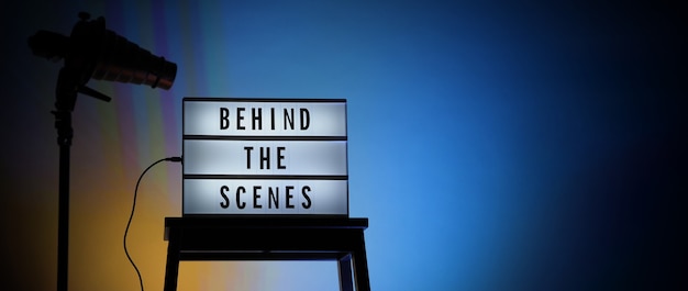 behind the scenes letterboard text on lightbox or cinema light box. movie clapperboard megaphone