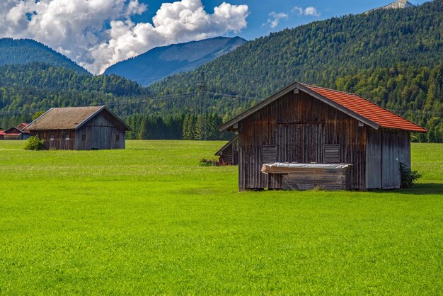 Scenic Alpine landscape with a green field and rural houses Upper Bavaria Germany