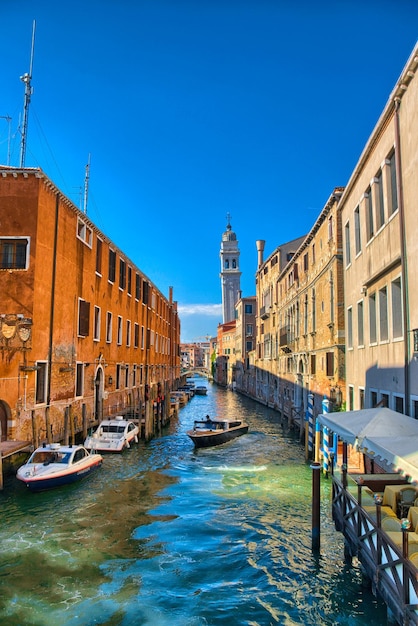 Scenic canal with Carabinieri boats Venice Italy HDR