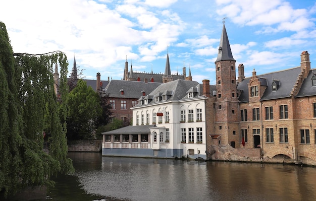 Scenic city view of Bruges canal with beautiful medieval colored houses and reflections