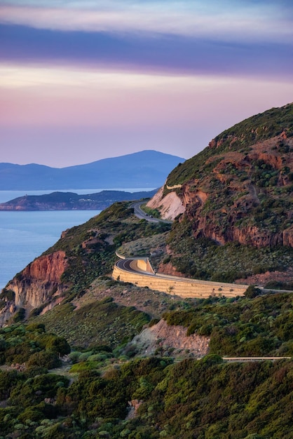 Photo scenic highway on the sea coast during sunny fall season sunset sardinia italy