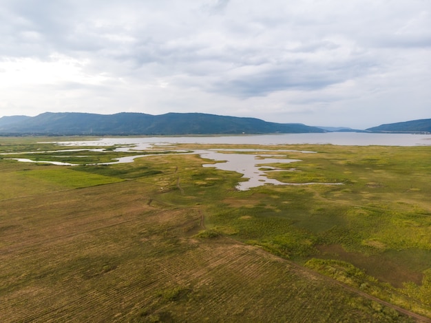 Scenic landscape aerial view of field river and basin